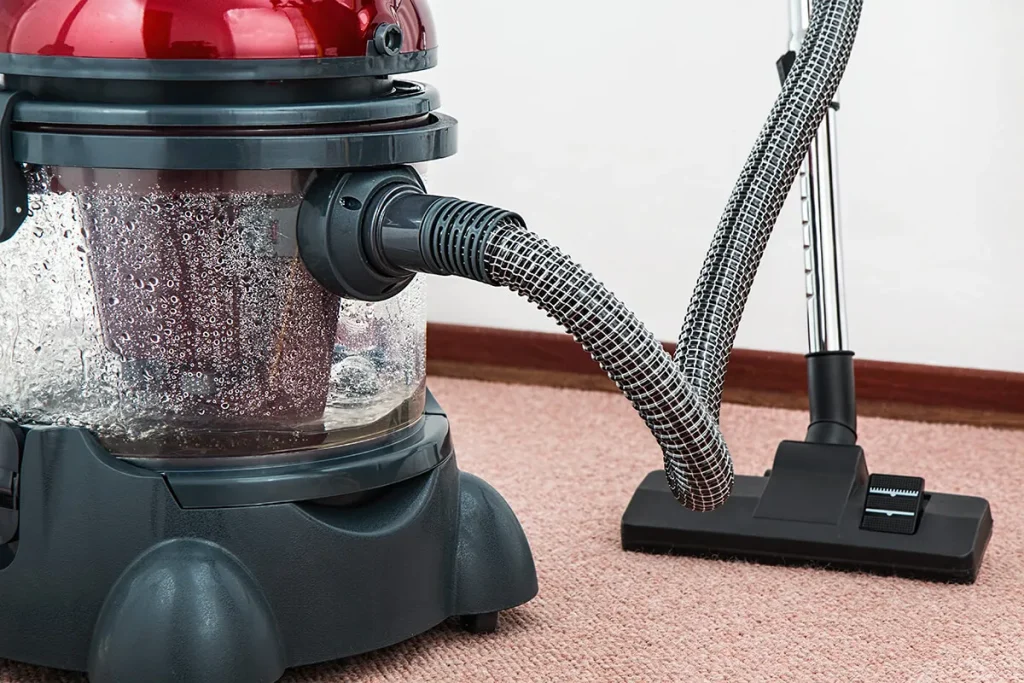 Carpet cleaning machine on a pink carpet.