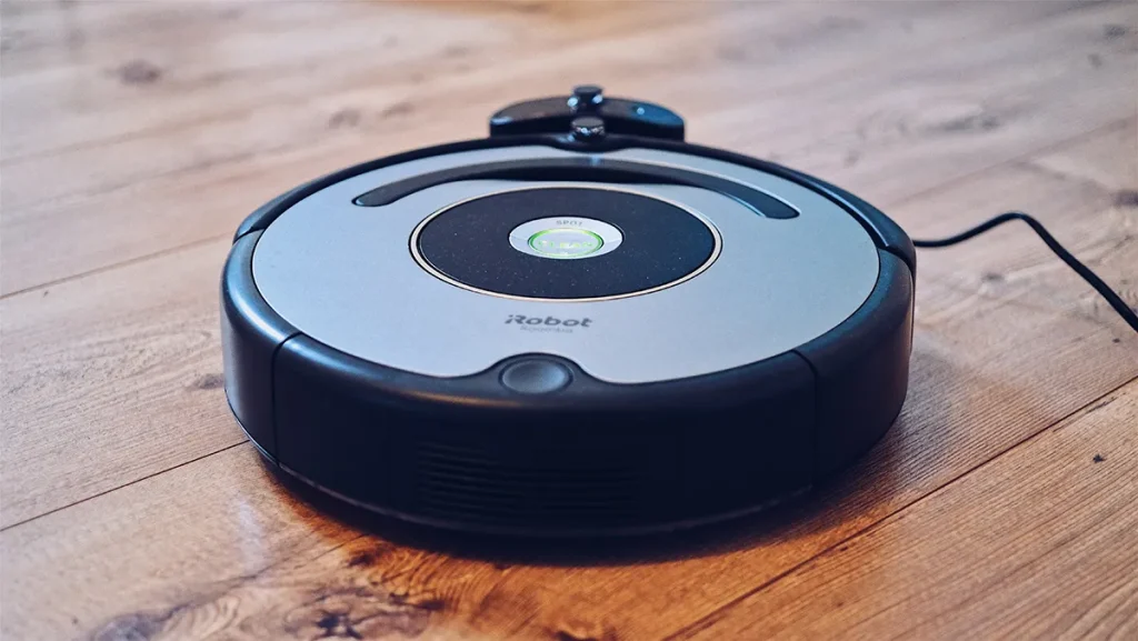 Robot vacuum on hardwood floor.