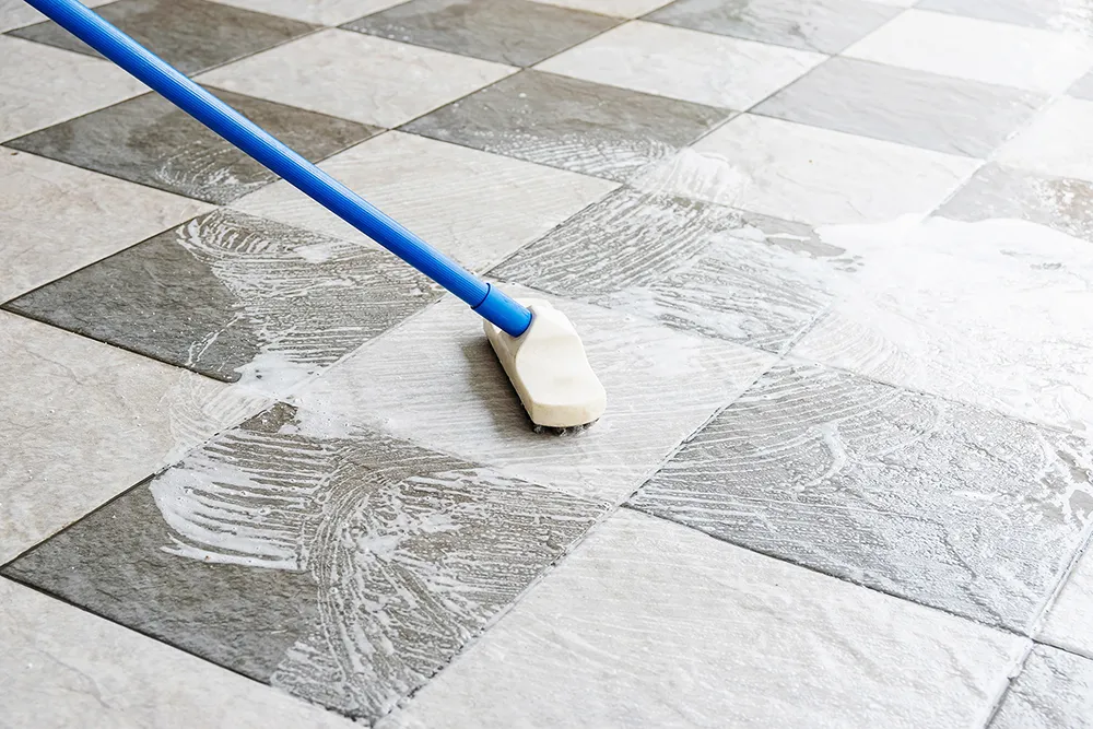 Stone tile floor being cleaned.