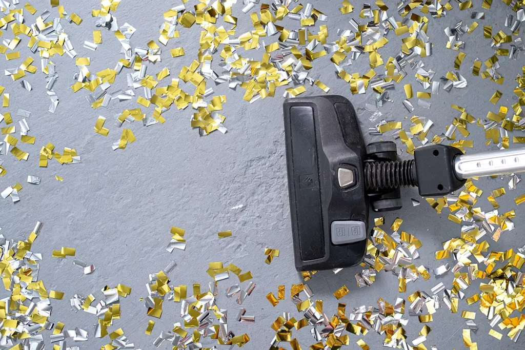 Vacuuming up gold and silver confetti.