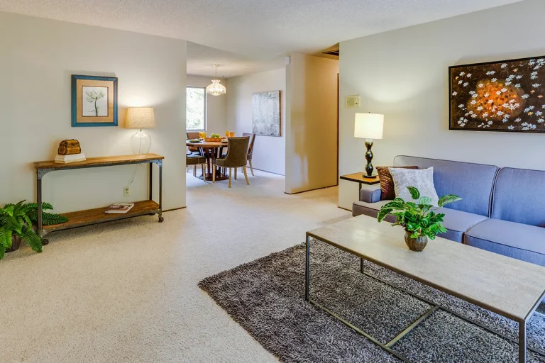 Living room and dining area with clean carpet.